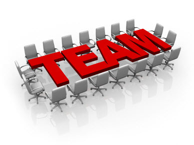 Stock image of the word TEAM across a board room table