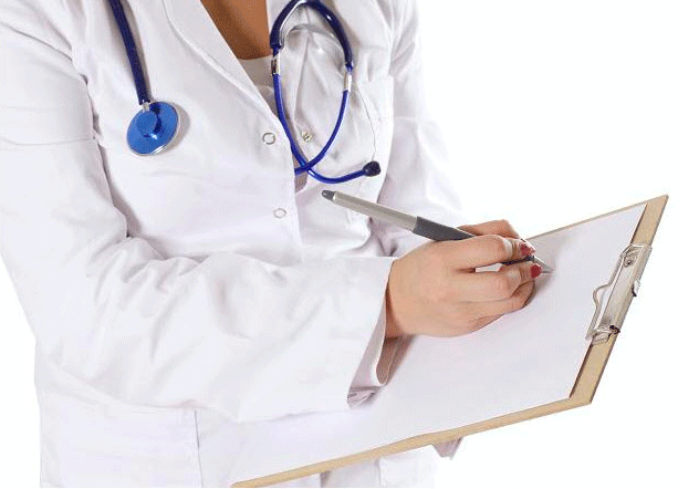 Stock photo of doctor writing on clipboard