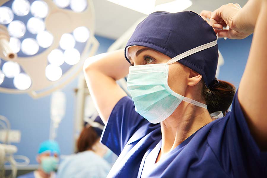 Picture of a surgeon putting her mask on